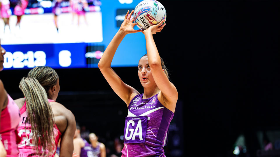 A photograph of a Loughborough Lightning goal attack player mid-shot during a netball game.