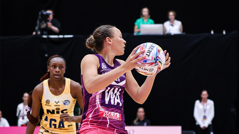 Hannah Joseph landing with netball in hand