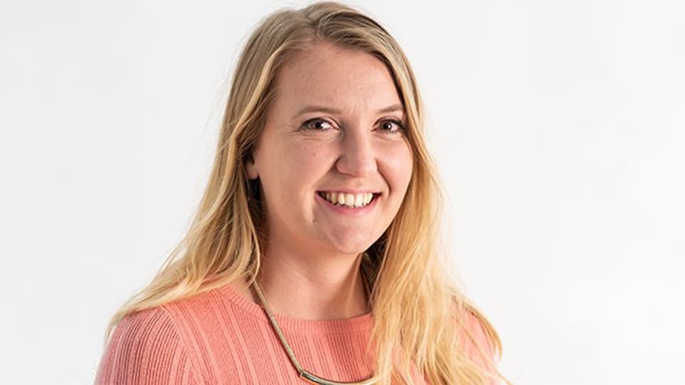 Olivia stood against a cream background