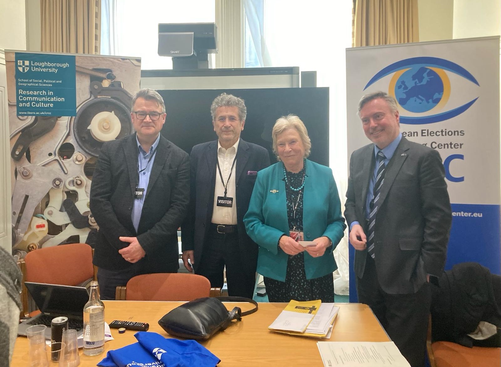 Speakers at the event stood together smiling in a room at the Houses of Parliament