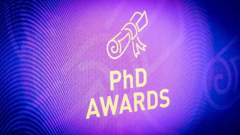 A purple projector screen with the text 'PhD Awards'