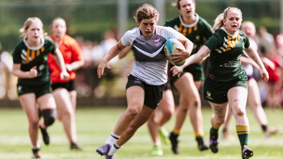 Loughborough and Nottingham students playing rugby on the University rugby pitch.