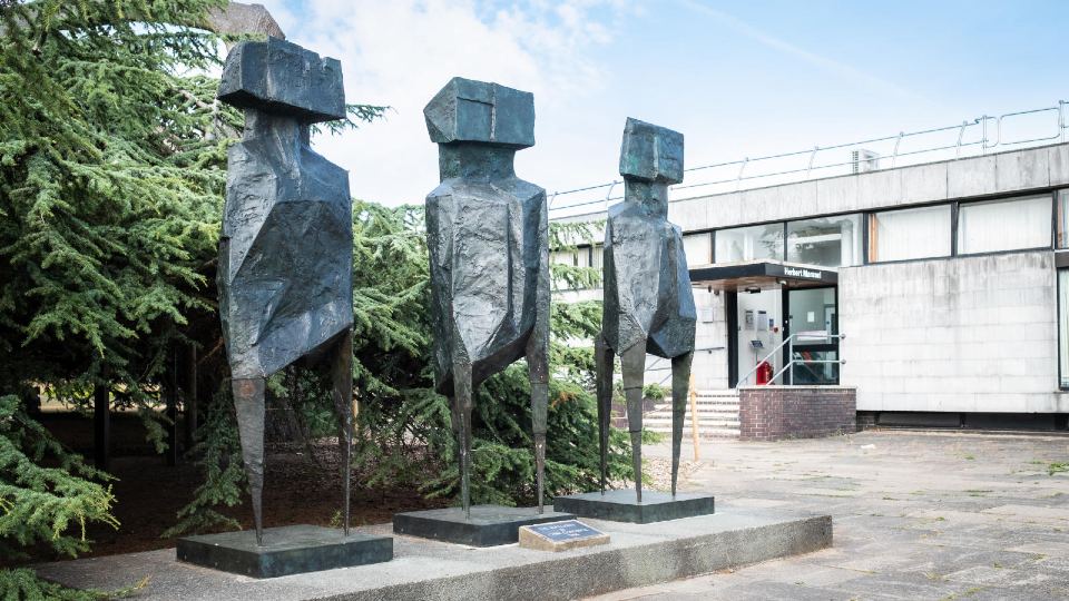Side view of The Watchers Sculpture outside the Herbert Manzoni Building on the Loughborough campus