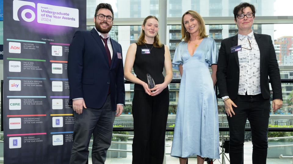 Tilly stood next to award hosts on stage receiving her award