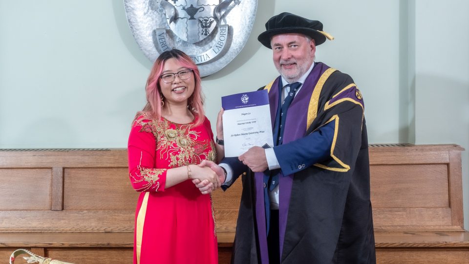 Huyen Le with the Vice-Chancellor being presented with the certificate