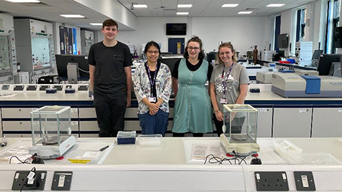 Four people stood in the biosesciences lab