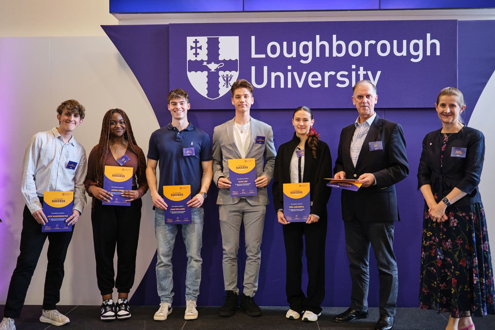Five students at a ceremony receiving awards from Rachel Thompson and Chris Gill