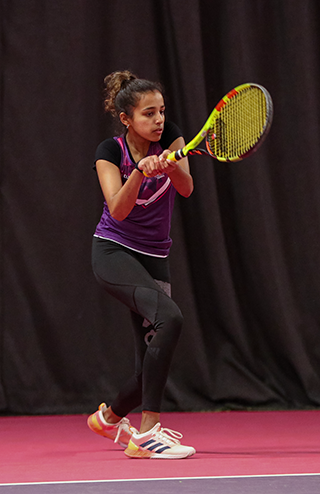 Neha hitting a tennis shot